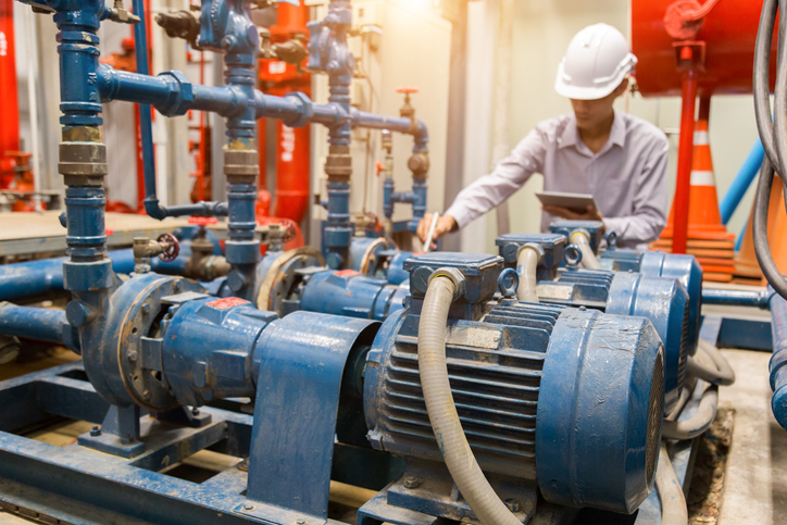 Asian engineer maintenance checking technical data of system equipment Condenser Water pump and pressure gauge , water pump. predictive maintenance services